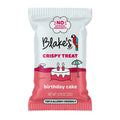 A single packaged snack bag for Blake's Brand Crispy Treats, flavor birthday cake. The packaging is white on top and pink on the bottom, featuring a cartoon illustration of a birthday cake with candles and a beach umbrella.