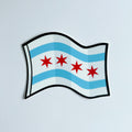 A sticker representing the Chicago flag, featuring horizontal stripes in blue, white, and red with a white crescent and a blue star on the white stripe.